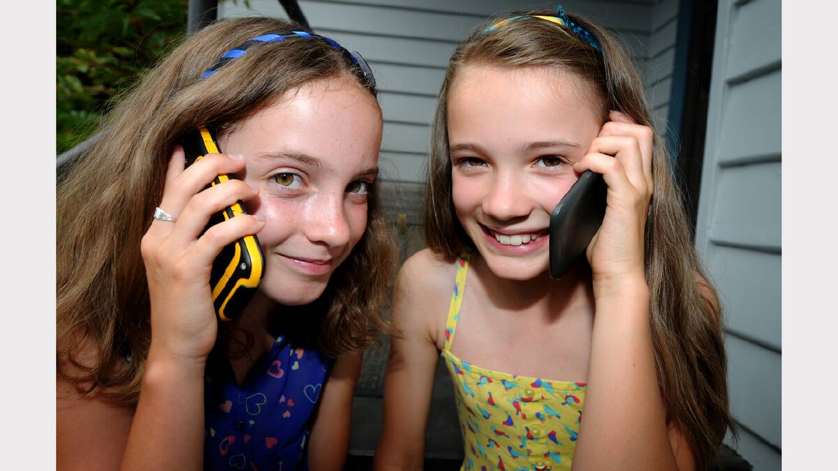 Twins Amelie and Miette Richardson, 10, do not own a mobile phone, but their parents are considering buying one for the girls for safety reasons. Picture: GEOFF ROBSON