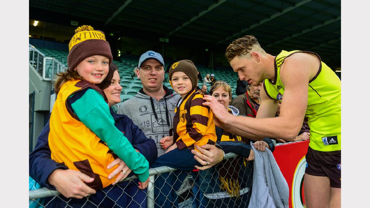 Hawthorn player Luke Lowden signs autographs for Chloe, 7, and Archie, 5, Payne of Norwood. PIcture: Phillip Biggs