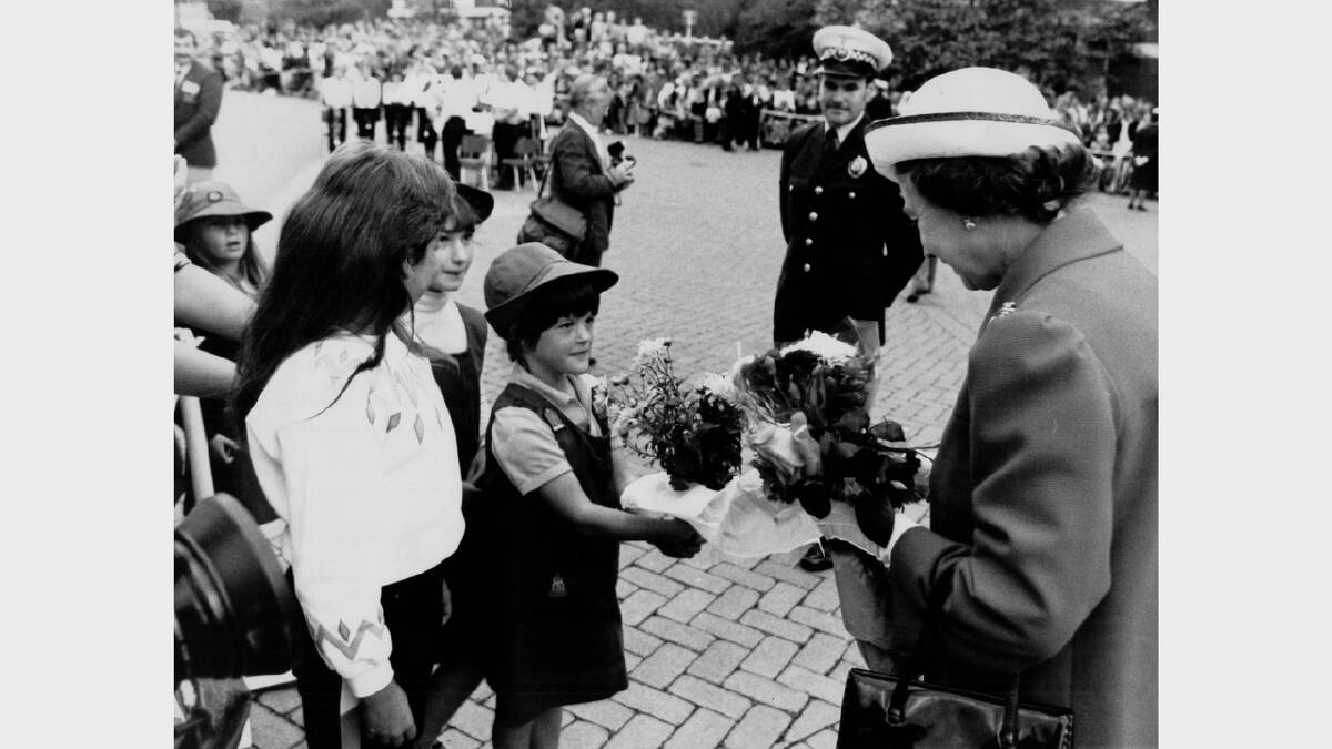 Queen Elizabeth and Prince Philip's 1988 royal visit | Sherryl O'Malley, 9, of West Launceston, Megan Saunders, 9, and Danielle Colson, 8, both of Prospect, hand bouqeuts to the Queen. 