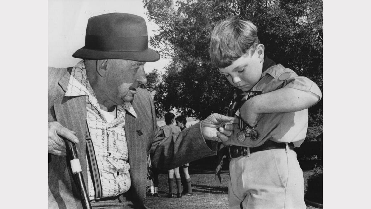 Anzac Day flashback gallery | Alby Mott explains to eight-year-old Clinton Eastley what his grandfather's medals were for. Scottsdale, 1992.