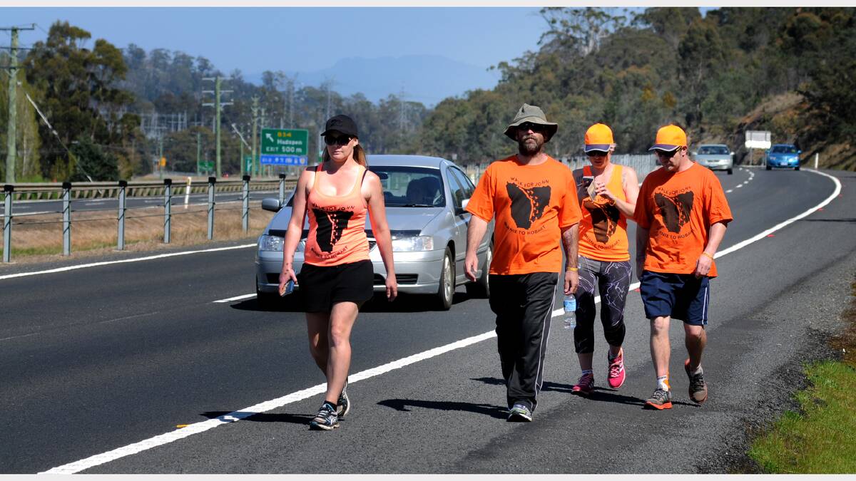Walk for John Opie House: Carol Slatter, Mark Whitney,Carly Fenech and Ty Fenech make their way into Launceston. Picture: GEOFF ROBSON