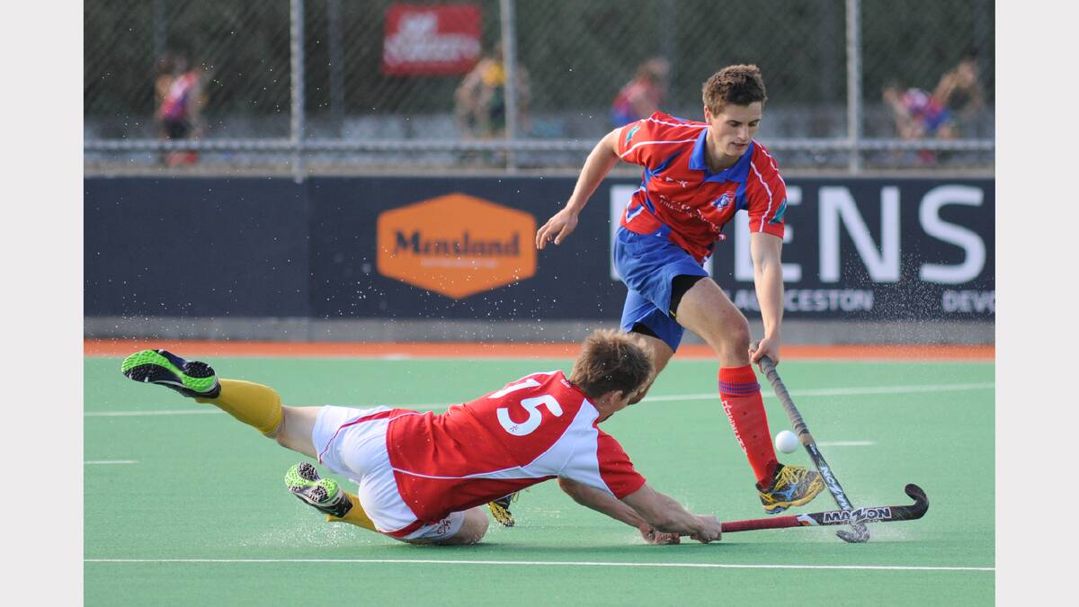 Queechy Penguin's Tom Moir crosses swords (or hockey sticks) with Burnie City Marians' Liam Grundy. Picture: Mark Jesser