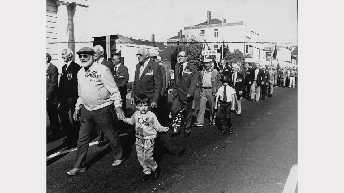 Anzac Day flashback gallery | Ollie Nielson marches with grandson Adam Cullen in Launceston, 1989.
