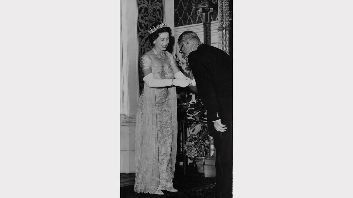 Queen Elizabeth and Prince Philip's 1963 royal visit | The Queen presents the Lord Mayor of Hobart (Alderman Osborne) with the C.B.E at a Government House investiture.