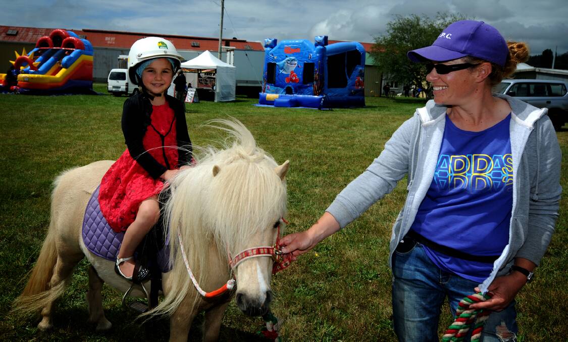 Adarie Bloomfield, 4, of Kimberley goes for a trot of horse Cha Cha, being lead by Justine Hartam, at yesteday's Deloraine show. Picture: Geoff Robson