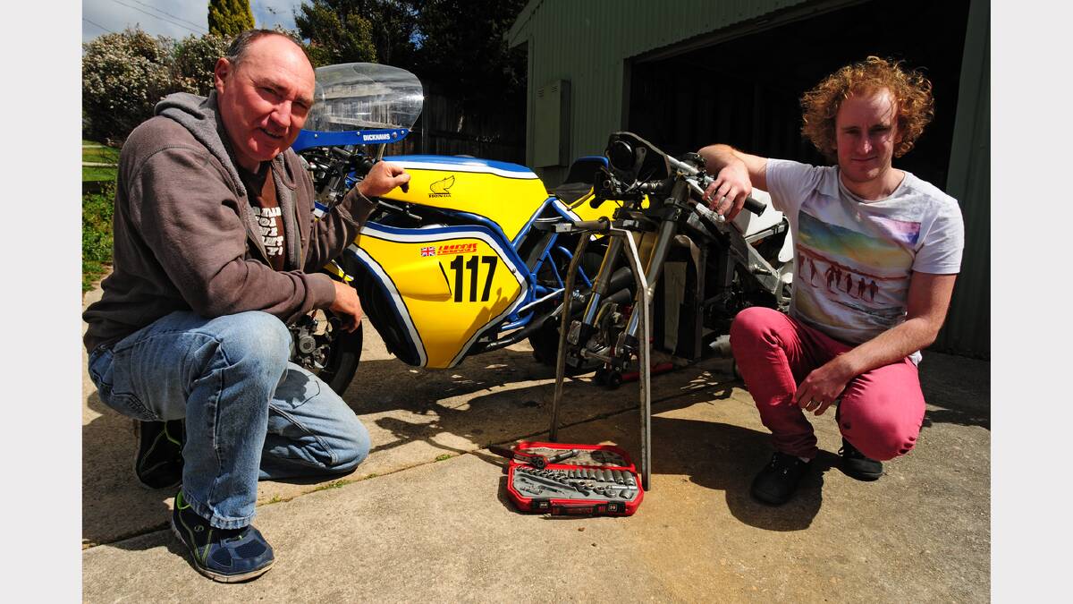 Mike and Nathan Greene, of Riverside's B-Spoke Design, work on the bikes they will race at Baskerville this weekend.
