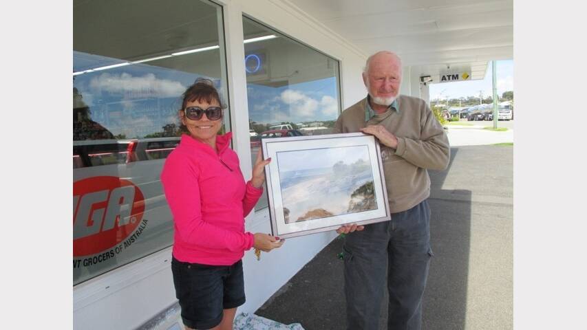 Gina McKenzie receives her second prize from Bridport Men's Shed president George Andrews.