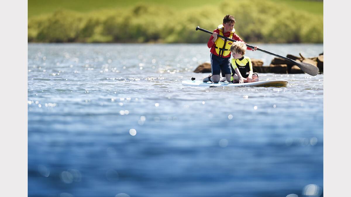 West Launceston neighbours Joseph Conway, 11, and Jasper Macalister Blake, 7, enjoy a paddle on Lake Trevallyn. Picture: SCOTT GELSTON