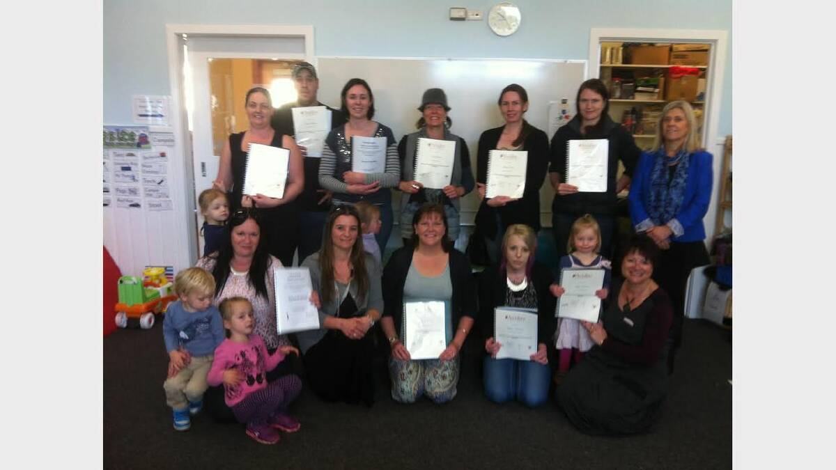 Parents and children celebrate the graduation of 13 participants from the On Our Patch course.