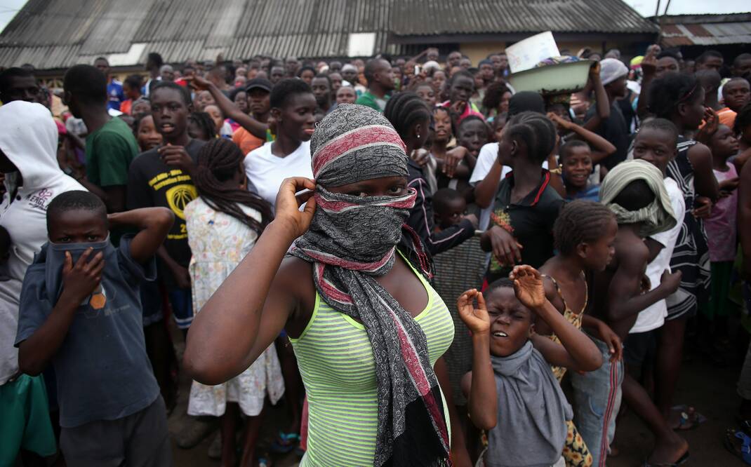 A crowd entering the grounds of an Ebola isolation centre in Monrovia, Liberia. Picture: Getty Images