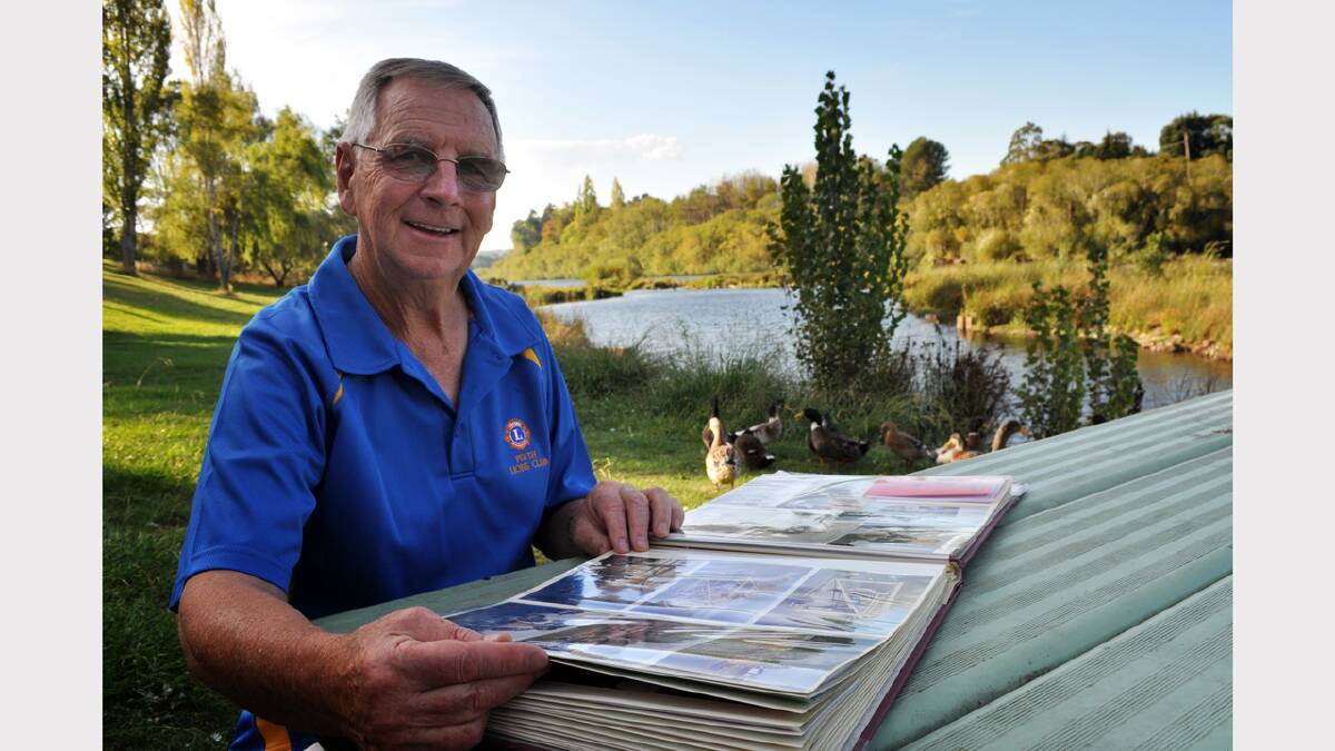 Perth Lions Club member Brian Shephard looks over some of the club's past fund-raising events on the banks of the South Esk River.