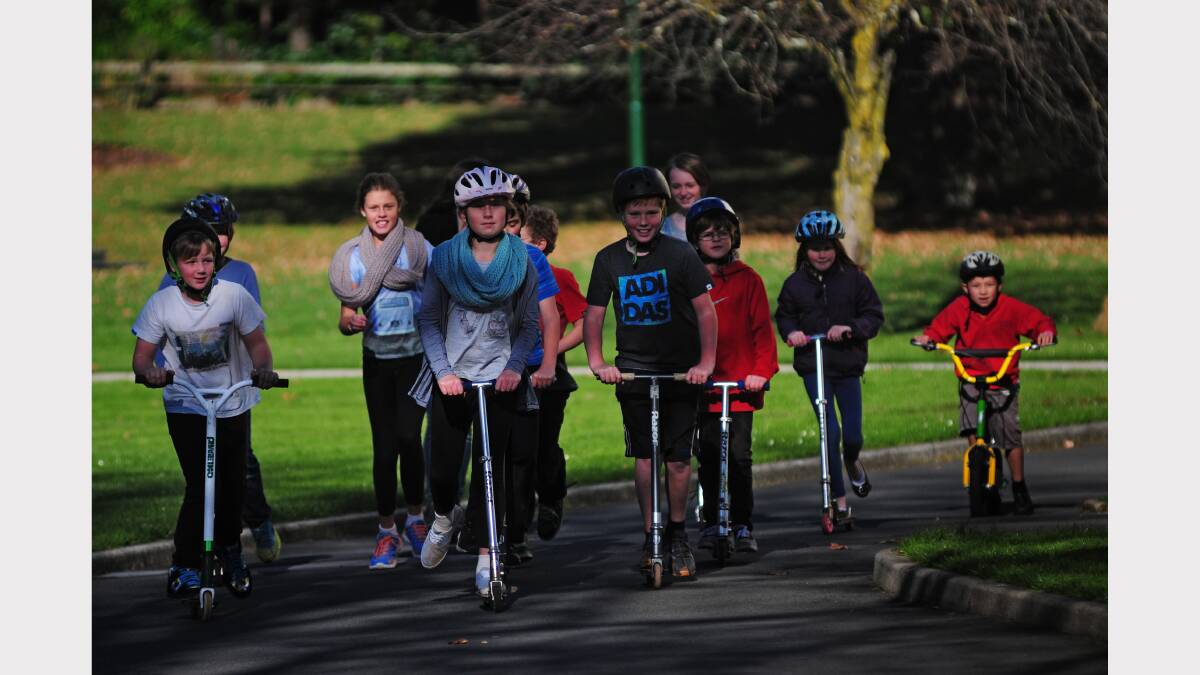 Penguin's Thomas Kinch, 10, Amelia Briggs, 12, and Braydon French, 11, lead their friends through Launceston's City Park today. Picture: Peter Sanders.