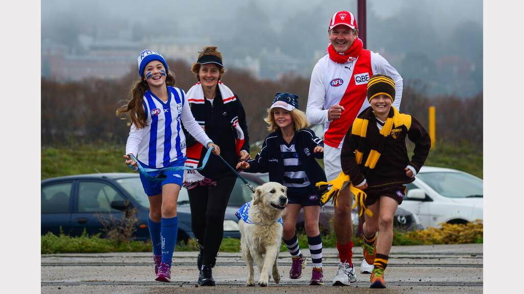 Skye with his footballer fan family Bill and Caroline Dowling of Longford, with Oscara, Olivia and Ma. Picture: Phillip Biggs.