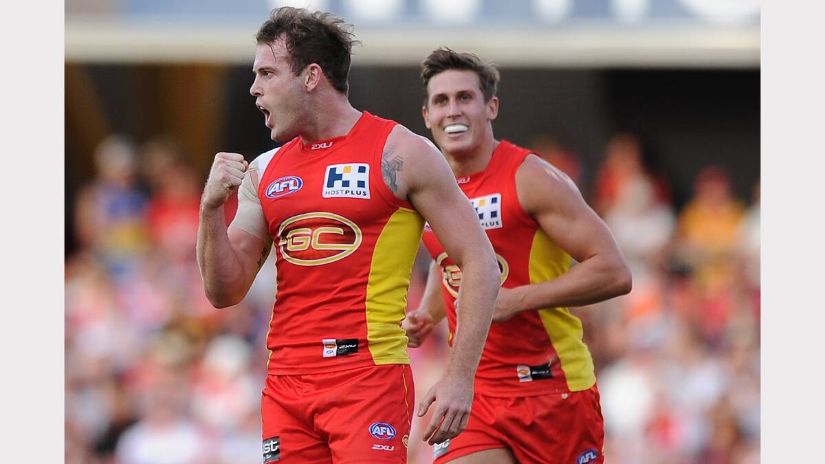 Luke Russell celebrates a goal for Gold Coast.
