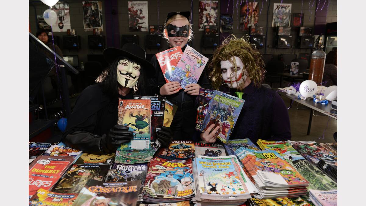 Rob Lukas as V, Mia White, 10, as Catwoman and Ryan McCarthy as The Joker at Guf Goodgames Launceston today.	
