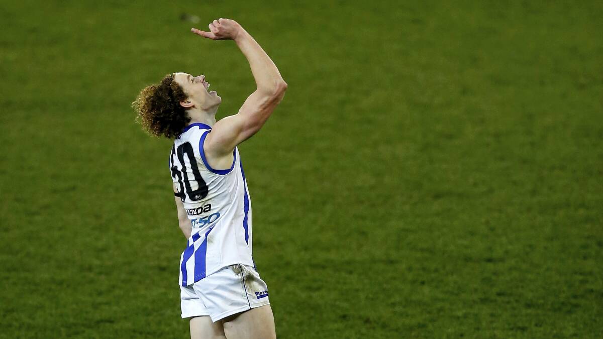 North Melbourne's Ben Brown  points to the sky  after kicking his first AFL goal in tribute to his late grandfather Jim Manson, in Sunday's win against Melbourne. Picture: GETTY IMAGES.