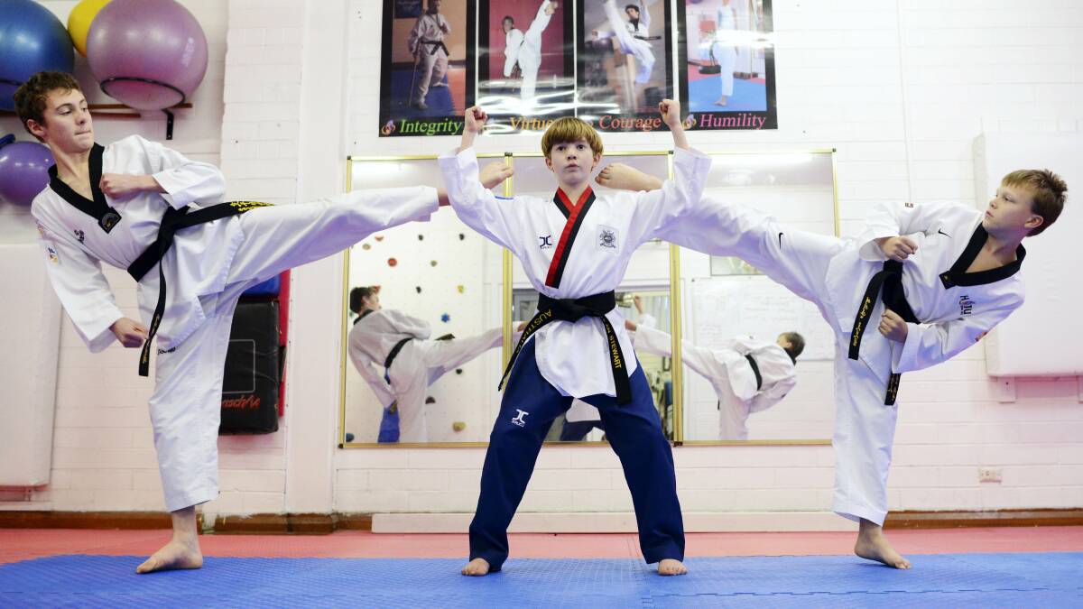  Isaac Wyley, 15,  Lachlan Stewart, 12, and  Edan Robotham, 12,  sharpen their  taekwondo skills during a training session. Stewart  has won the right to  represent Australia at the world titles in Mexico in late October. Picture: SCOTT GELSTON