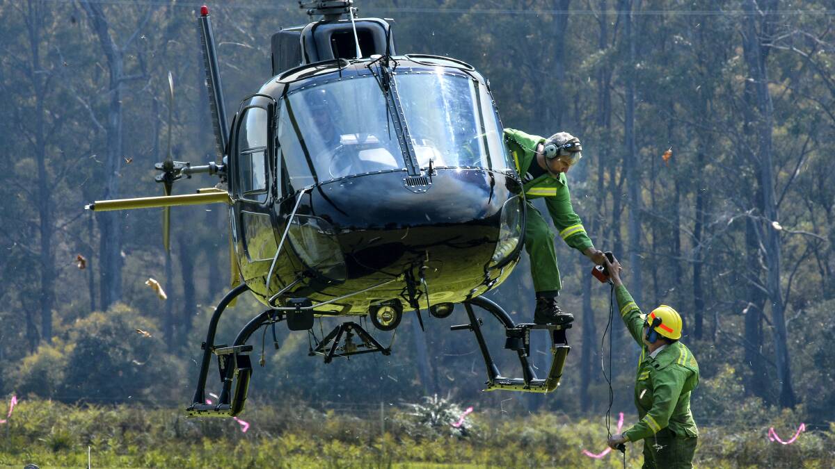 Forestry operations officer Bob Knox takes the controls of the fire dragon from Forestry officer Doug Johnson. 
Picture: NEIL RICHARDSON