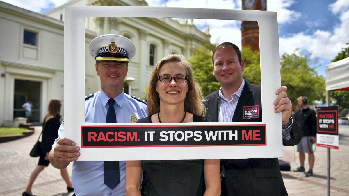 Tasmania Police Inspector Michael Johnson, City of Launceston community development and safety officer Nathalie Servant and Alderman Danny Gibson show their opposition to racism. Picture: SCOTT GELSTON