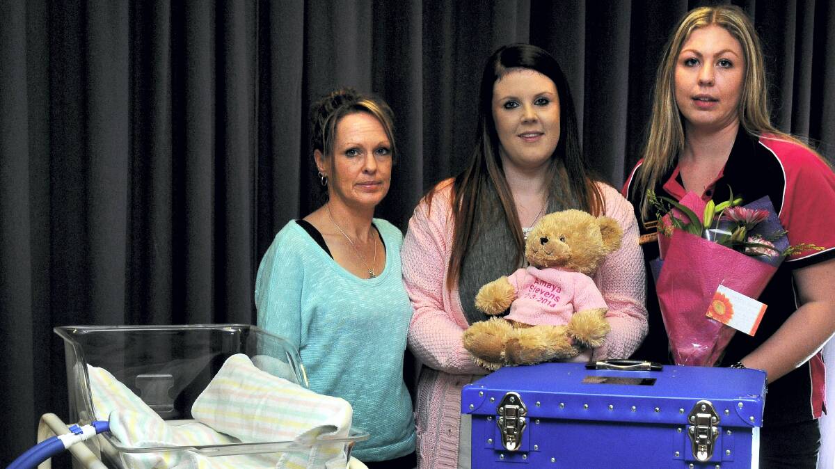Rosebery fund-raiser Toni Takawe, Burnie mother Antonia Fitzpatrick and The Fairy Godmothers president Jess Tabart with the cuddle cot they donated to the Launceston General Hospital.  Picture: NEIL RICHARDSON