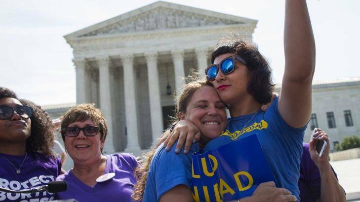 Bethany Van Kampen (left) hugs Alejandra Pablus as they celebrate during a rally at the Supreme Court in Washington.