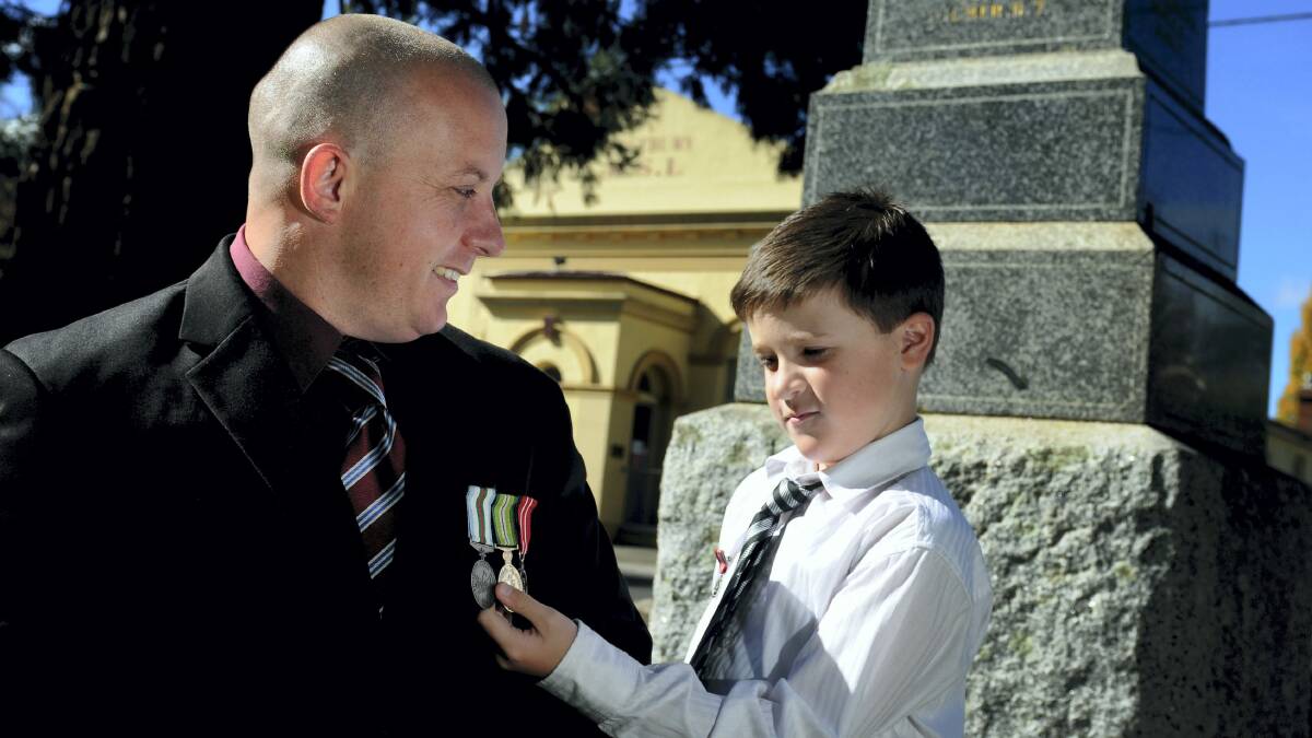 Westbury RSL's Tony Keefe with his son Dylan Keefe, 8, both of Launceston. Mr Keefe would like to see children learn more about the significance of Anzac Day. Picture: GEOFF ROBSON