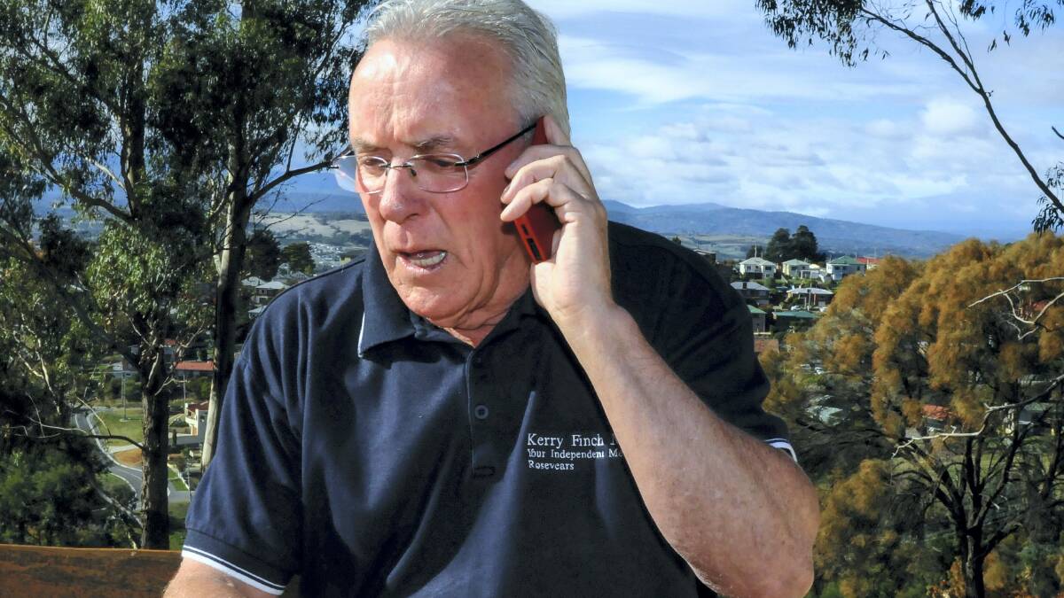 Re-elected member for Rosevears in the Legislative Council Kerry Finch on the phone taking calls of congratulations. Picture: NEIL RICHARDSON
