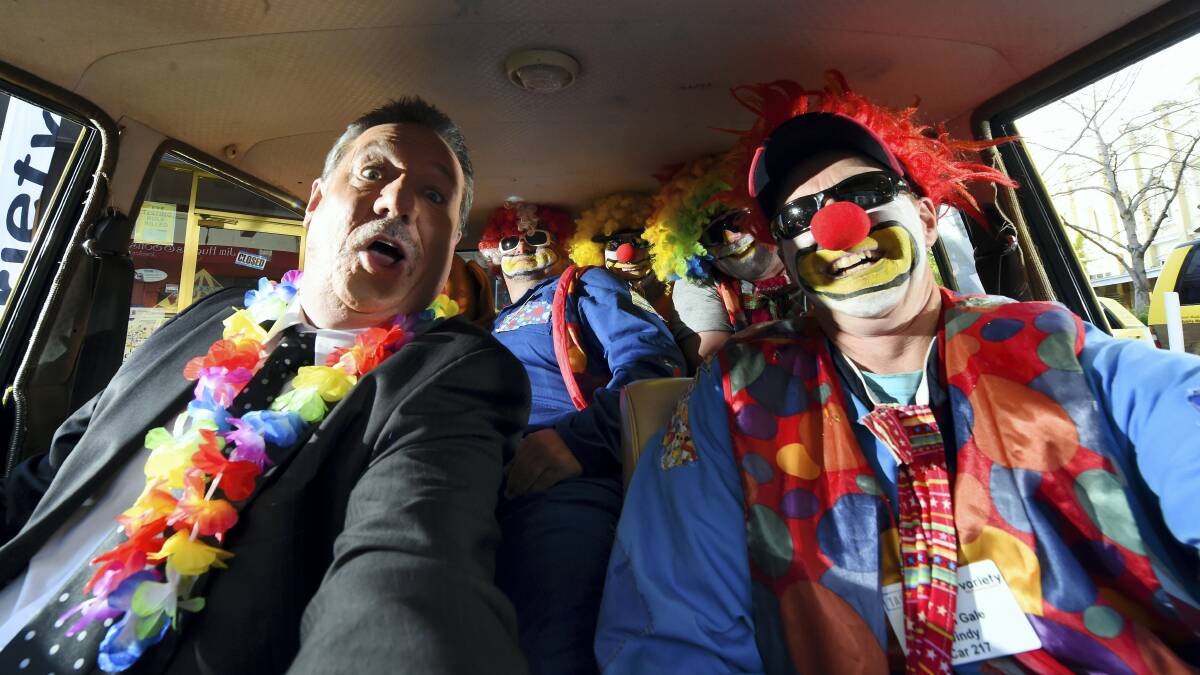 Southern Cross weather presenter Peter Murphy hams it up in a car with the Tash Bash Clowns. Picture: MARK JESSER 
