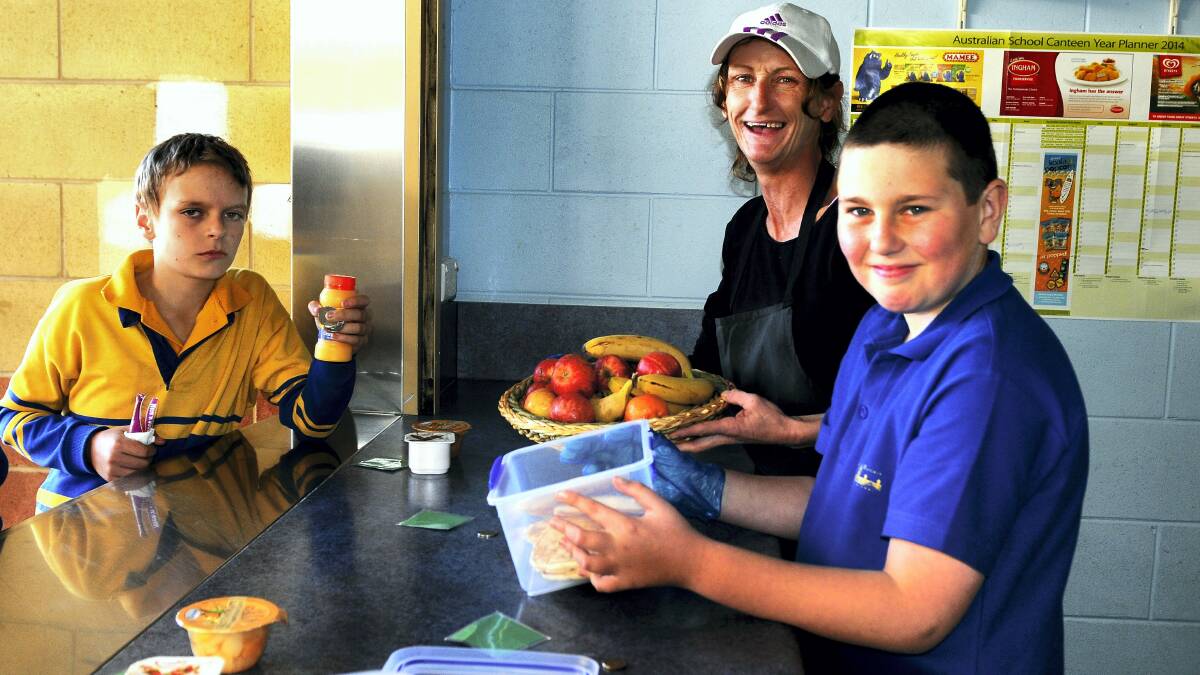 Mowbray Heights pupils Tayte Butler and Paige Nicholas buy lunch from canteen manager Teyna Triffitt. Picture: NEIL RICHARDSON