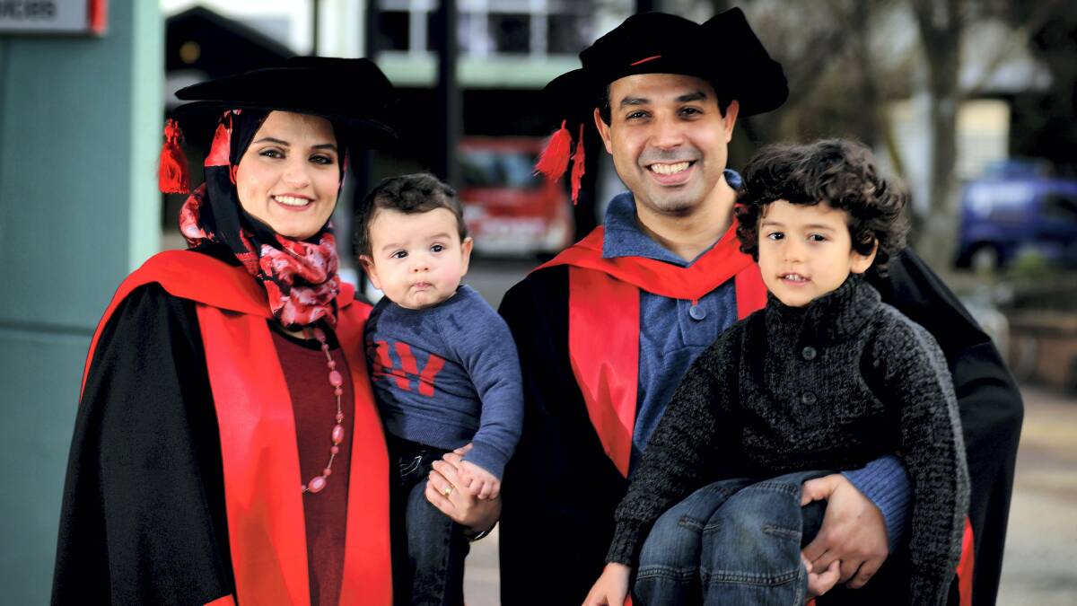University graduates Sofia Omari and her husband Asal Al-Odat, of Newnham, with their children Karam, six months, and Awsam, 3.  Picture: GEOFF ROBSON
