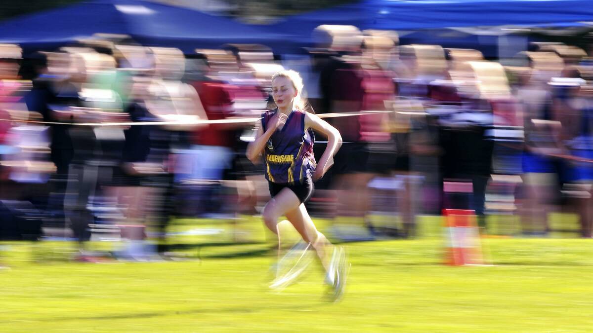 Riverside's Amelia Bransden  charges to the line to  win yesterday's  grade 8 girls' event at the school cross-country titles. Pictures: SCOTT GELSTON