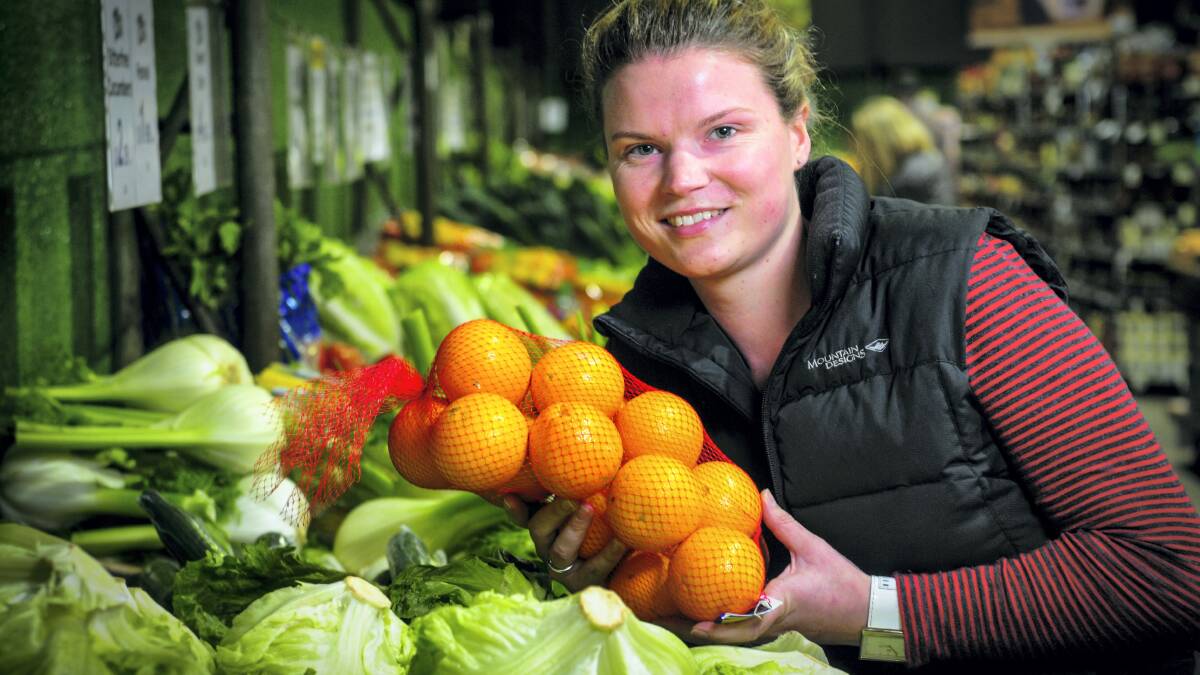  Family Food Patch program manager Emily Rataj  with fruit and vegies at Young’s Vegie Shed, Launceston. Picture: PHILLIP BIGGS