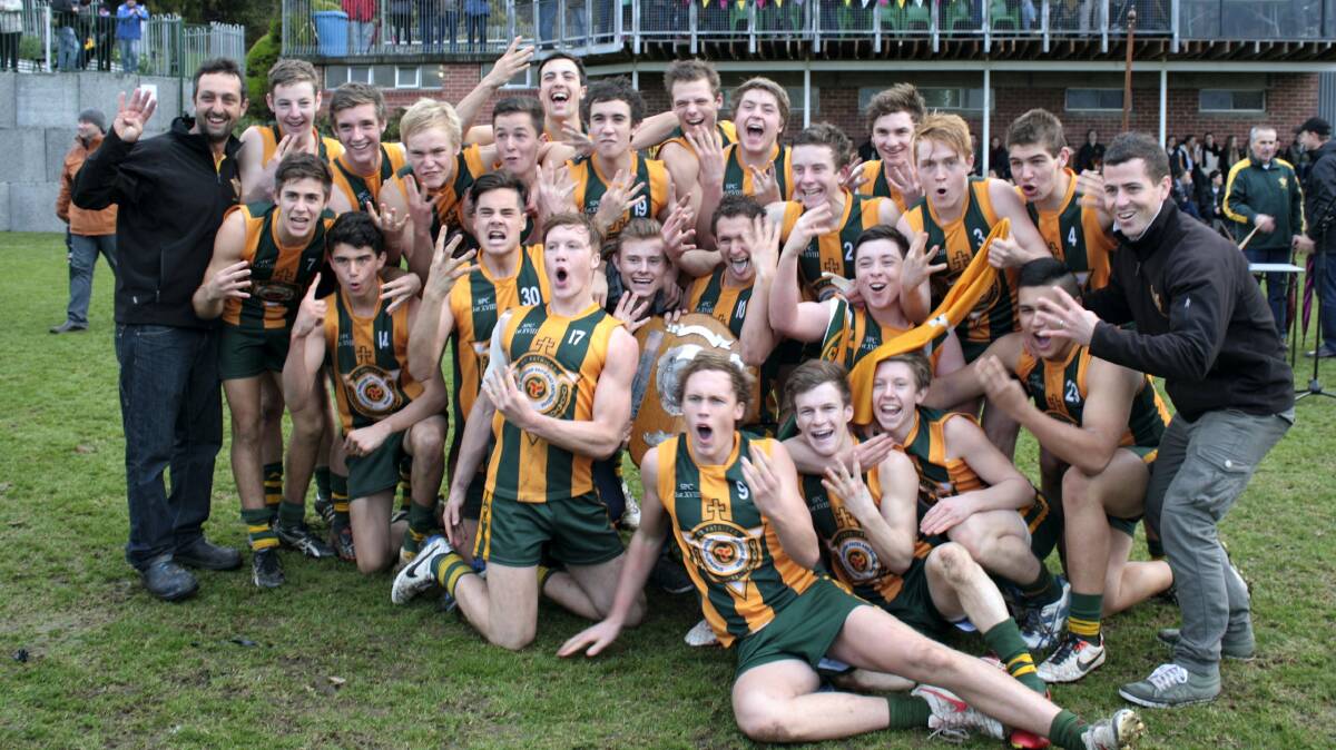 Members of the St Patrick's senior football team celebrate after defeating Hutchins 11.11 (75) to 5.10 (40) in Saturday's  SATIS grand final at Hutchins. 
