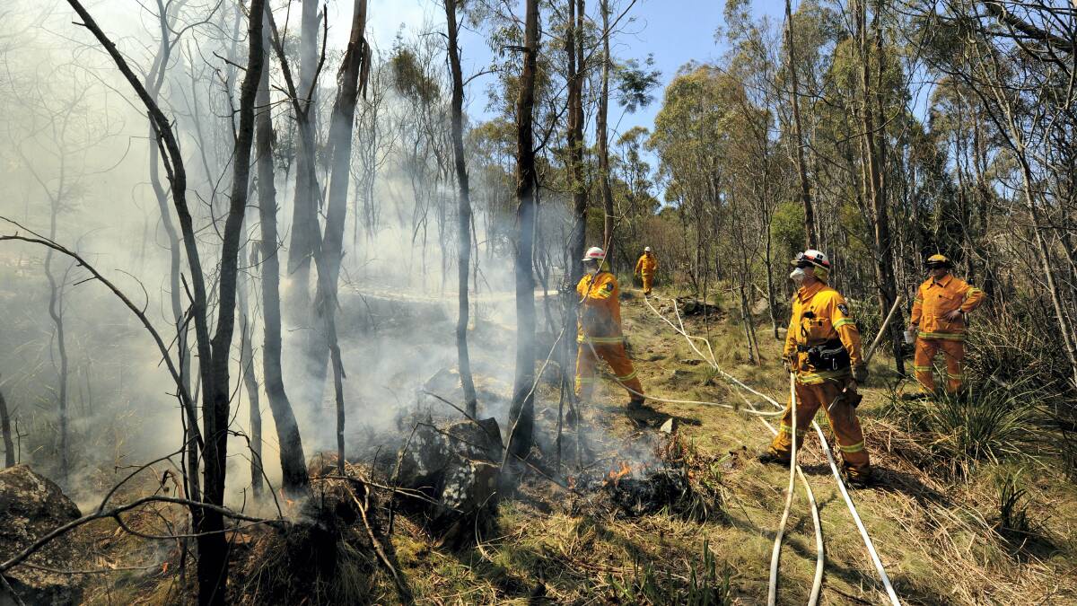 Firefighters launch a strategic burn-off to protect the Travellers Rest community.