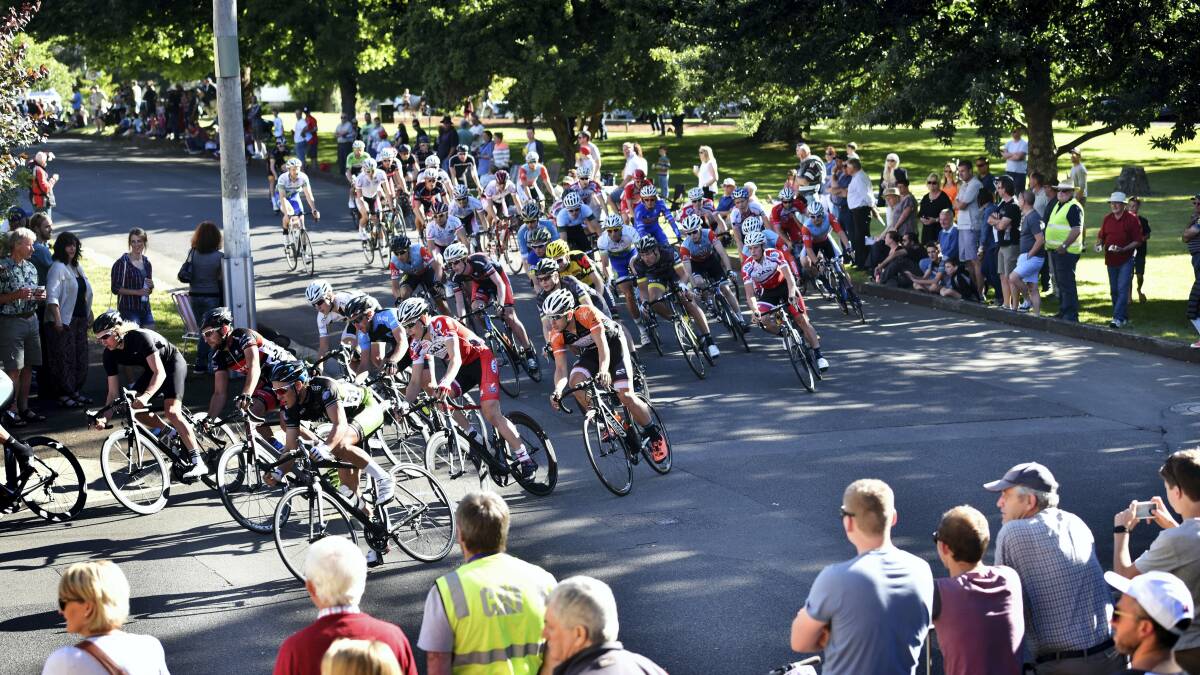 A crowd gathers to watch the field round the corner onto Lyall Street during the first lap of the Westbury Cycling Criterium yesterday. Pictures: SCOTT GELSTON
