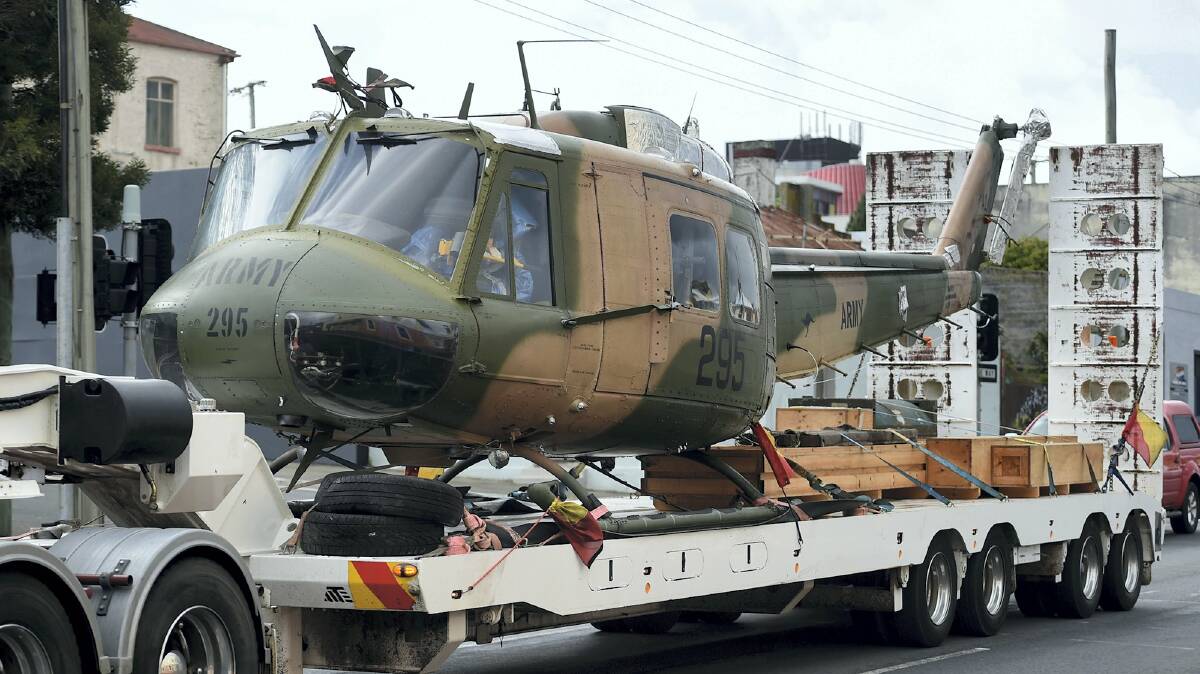 A former Vietnam War helicopter being transported through Launceston yesterday, destined for a new home at Scottsdale. Picture: MARK JESSER