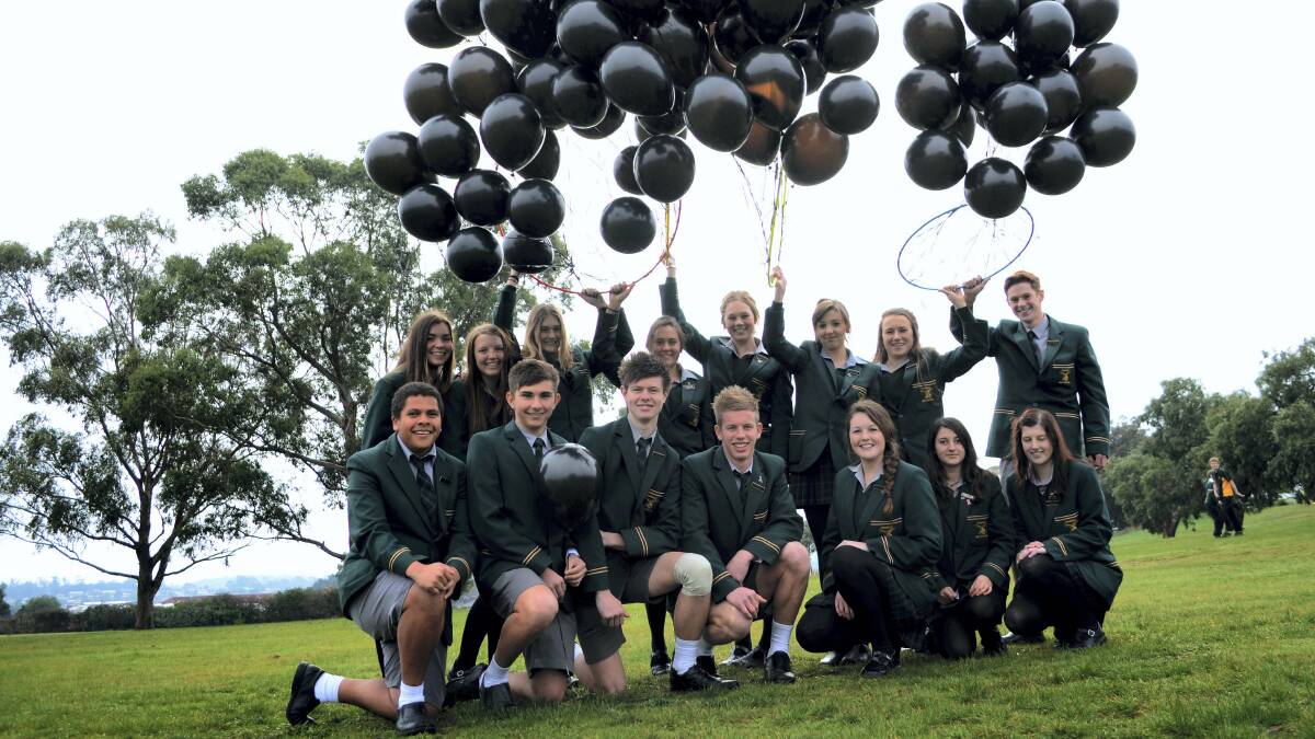 Prospect High School Student Leadership Board members with black balloons sold in support of the Johnston Family Pledge Appeal.