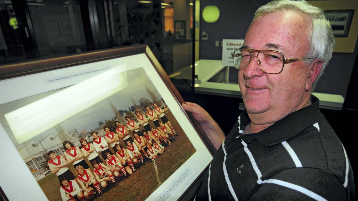 Former City-South player Stephen Hortle looks at a photo of City-South's 1974 state premiership-winning team, of which Hortle was a member. Picture: PETER SANDERS
