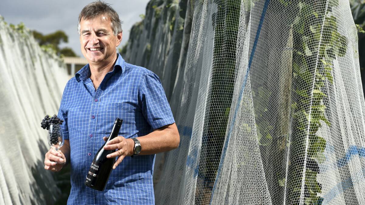TasTAFE wine industry teacher Mark Brewer with Eight Rows on Campus wine that is produced from the vineyard at the Alanvale campus.  Picture: MARK JESSER