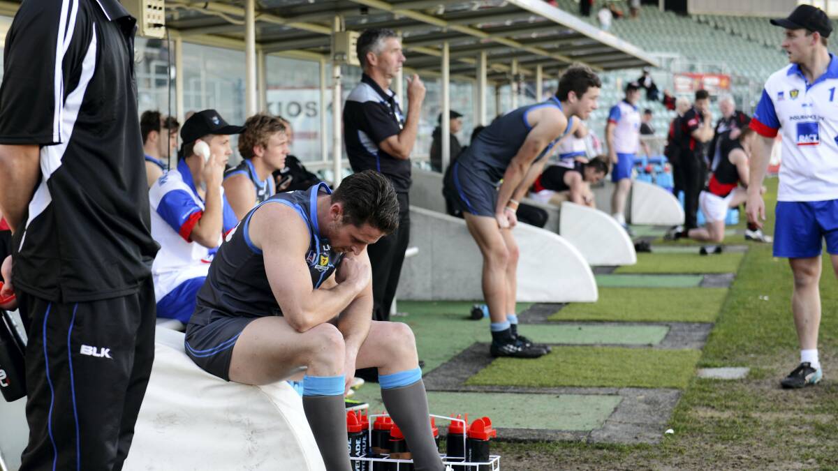Western Storm coach Mitch Hills sits dejected on the edge of the interchange during the final term at Aurora Stadium yesterday.   Pictures: SCOTT GELSTON