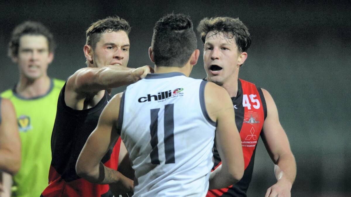 North Launceston’s Taylor Whitford and Callen Young deep in discussion with Western Storm player Darryn Thomas in last night’s match at Aurora Stadium. Picture: MARK JESSER

