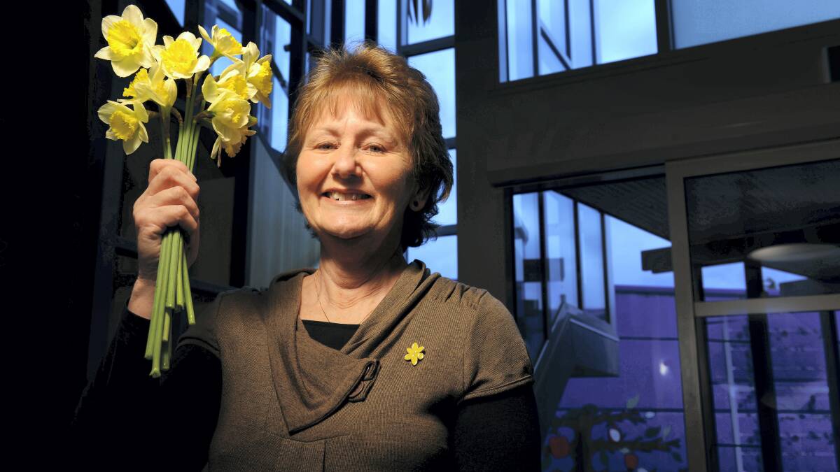 Cancer Council volunteer Sandra Mackrill with a bunch of daffodils at the Northern Cancer Support Centre. Picture: SCOTT GELSTON
