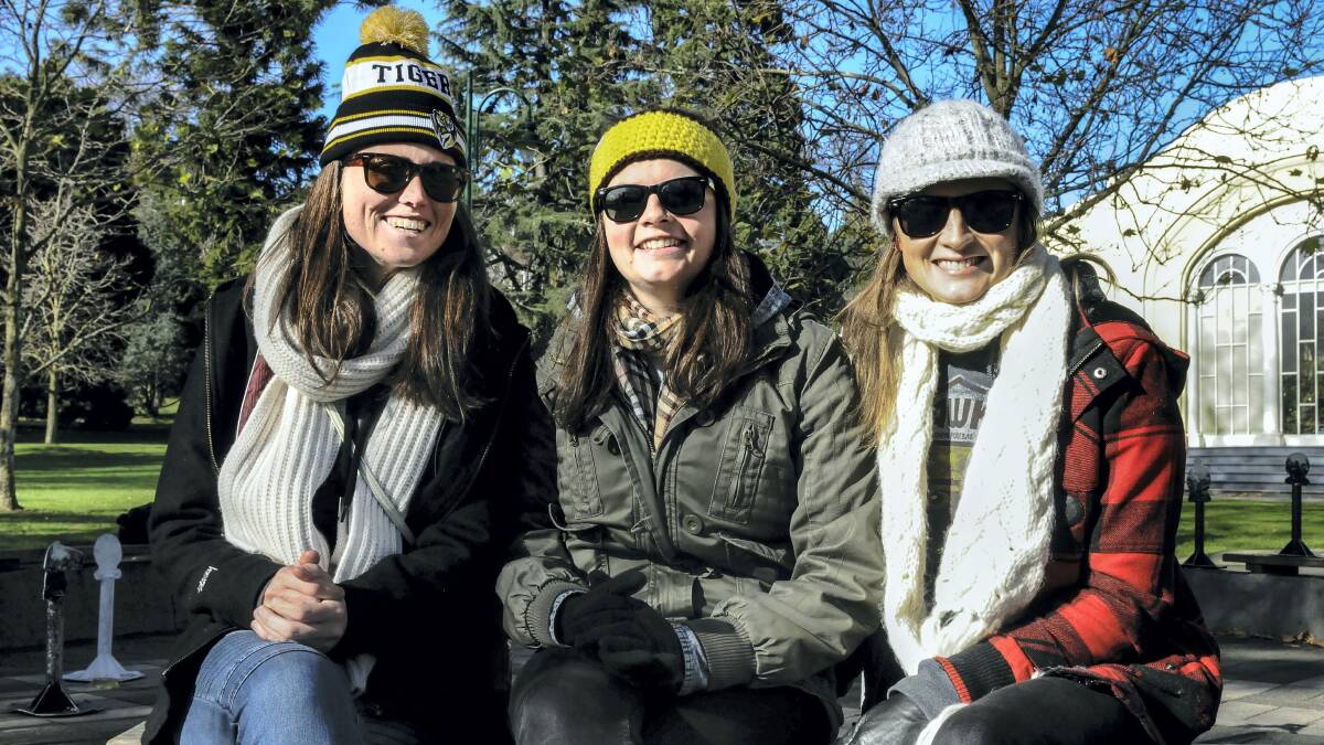 Melbourne visitors Casey Hawley and Penelope and Julia Cleghorn came to Tasmania for the AFL game in Launceston on Saturday.  Picture:  NEIL RICHARDSON