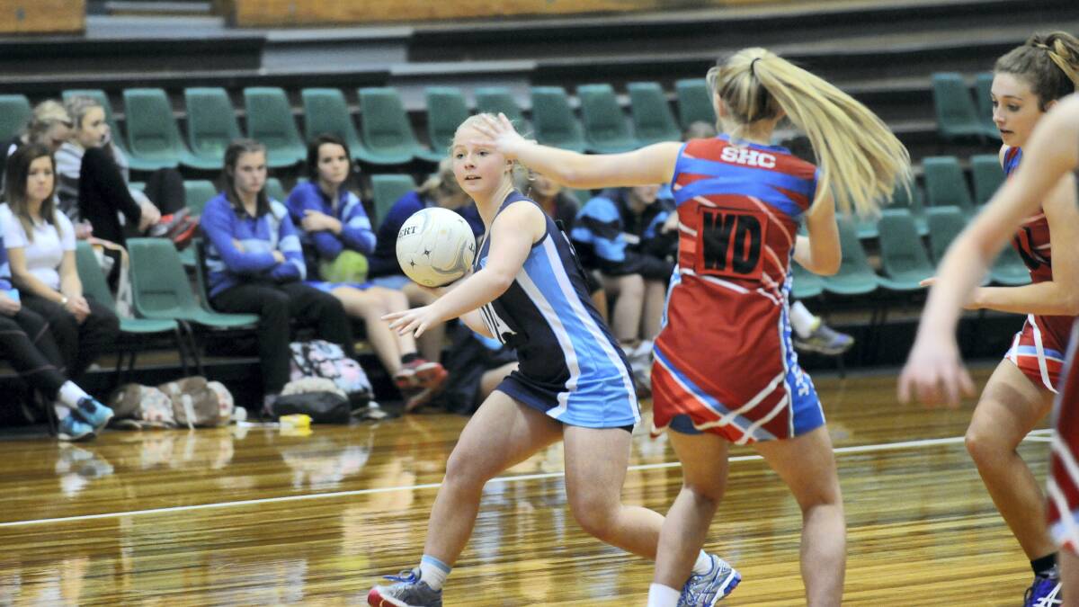 Netball final action between Marist and Sacred Heart