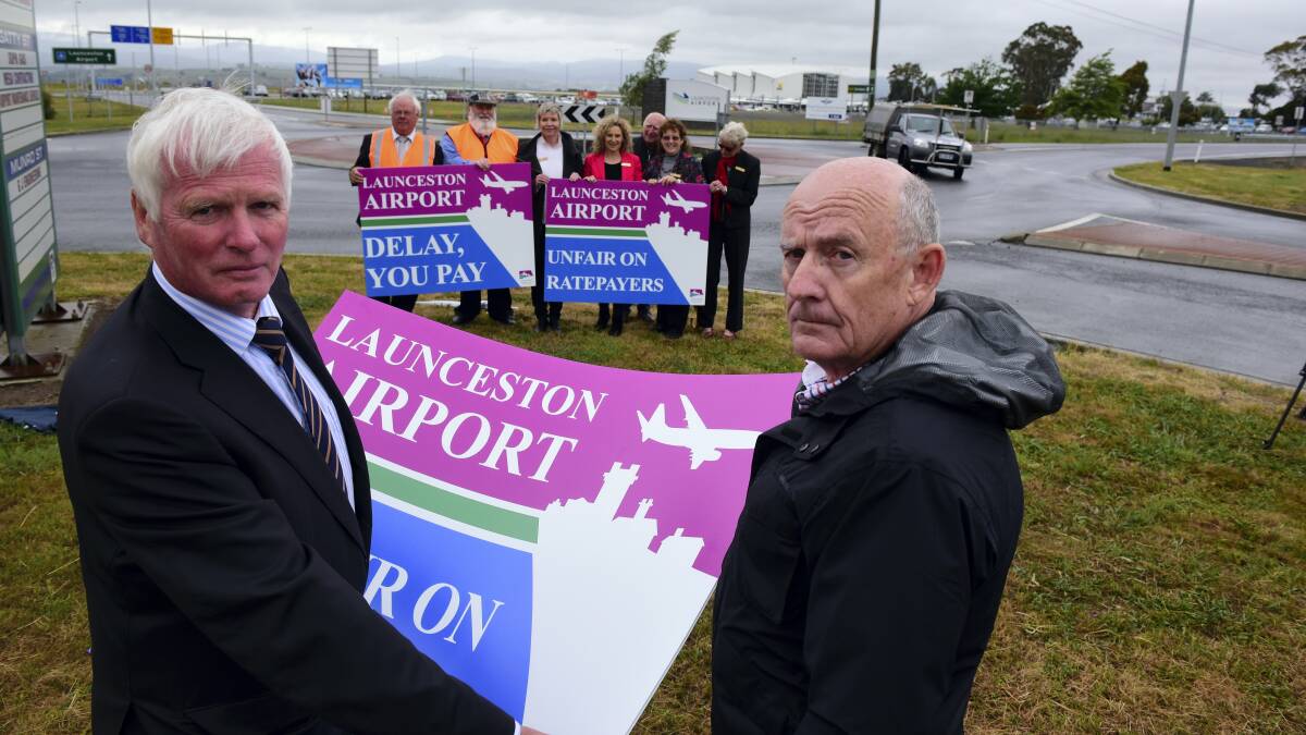 Northern Midlands mayor David Downie and Australian Mayoral Aviation Council executive director John Patterson	at the entrance to Launceston Airport.	

