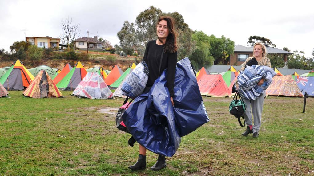 Jessica Turland-Rhook and Ailish McCorkell packed up their flooded and ripped tent and prepared to head home. Picture: NONI HYETT
