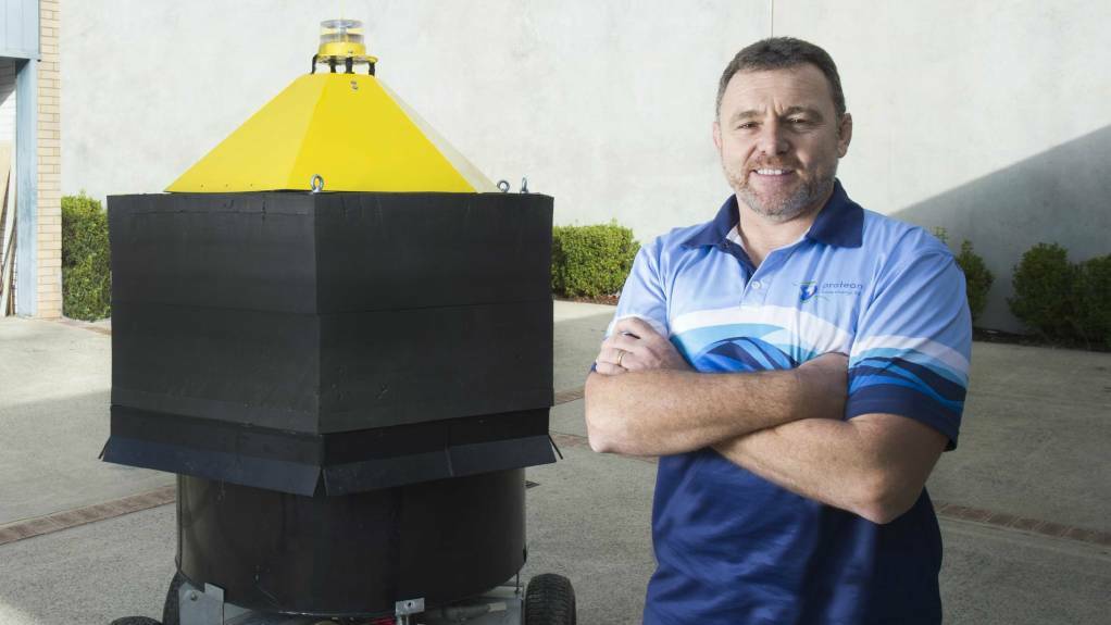 Protean Wave managing director Bruce Lane with a wave energy converter buoy.
