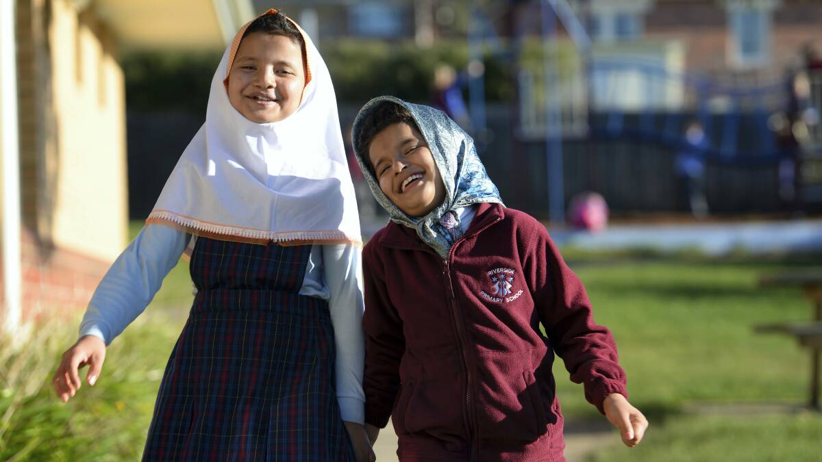 Sisters Samira, 10, and Mohadeseh Heidari, 8, enjoyed their first day in an Australian school,  Riverside Primary, after arriving in the country two months ago from Afghanistan.
