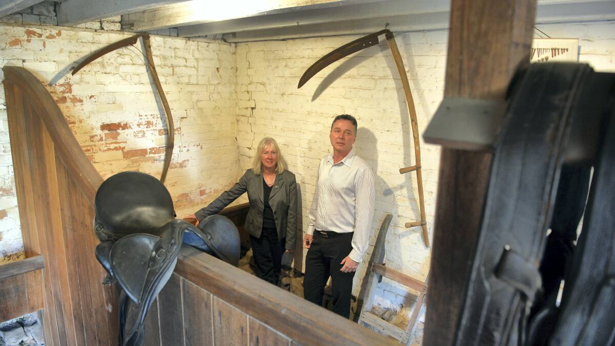 Franklin House property manager Hilary Keeley and  National Trust acting managing director Matthew Smithies show the cracks in the stable walls.  Picture: PAUL SCAMBLER