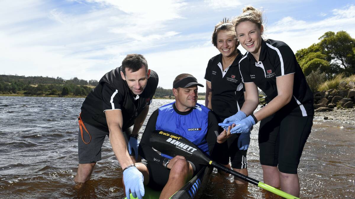 University clinical exercise physiologist Stephen Stone, kayaker Luke O’Garey and exercise science students Kahlia Perry and Clare Goss work to analyse O’Garey’s blood lactate profile while he works out.  Picture: MARK JESSER
